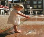 Iconic 2001 picture of girl playing with fountain water